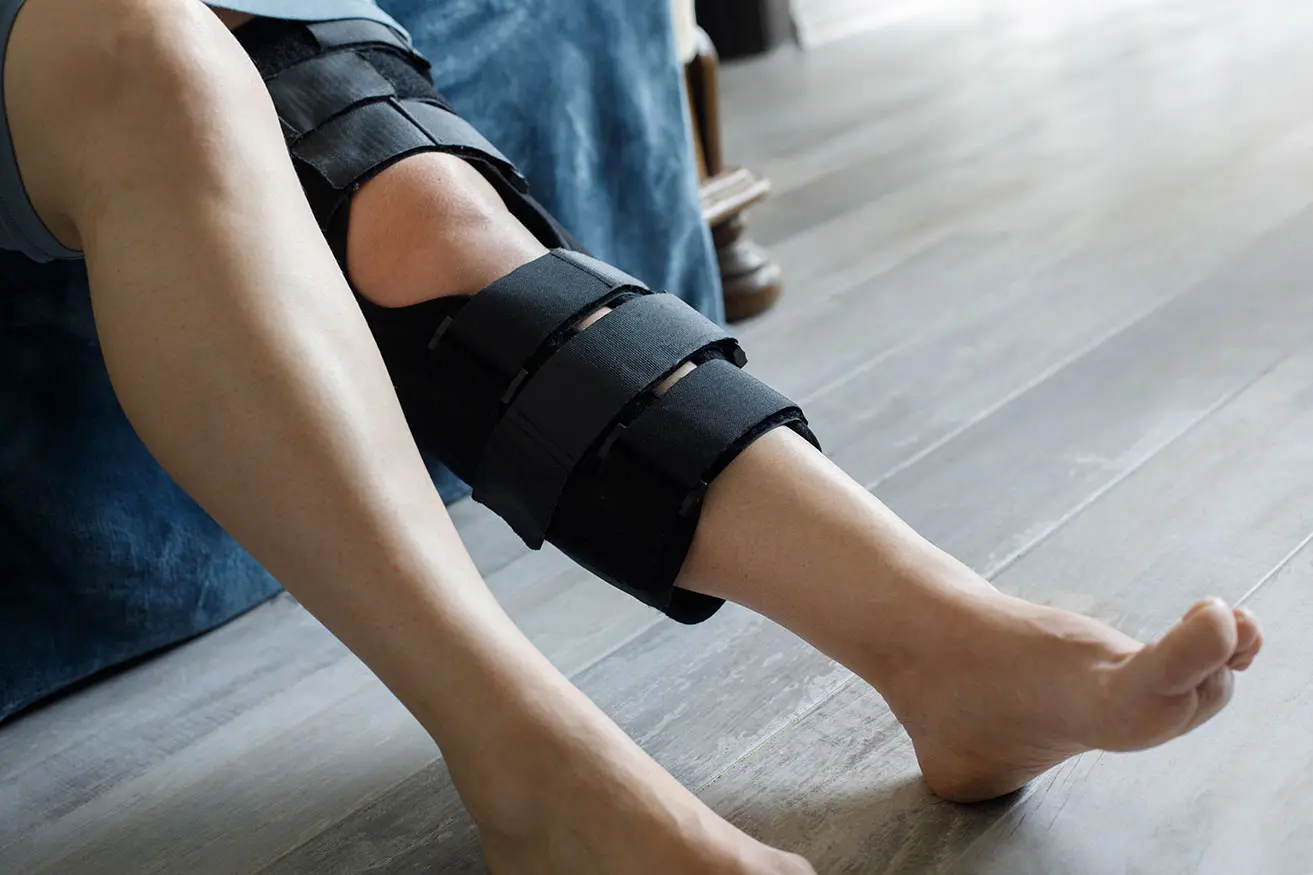 A man wearing a knee brace during ACL recovery and post-surgery rehabilitation