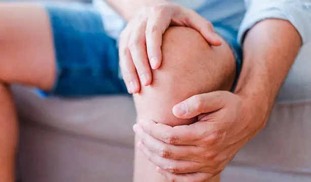 A man experiencing knee pain due to arthritis