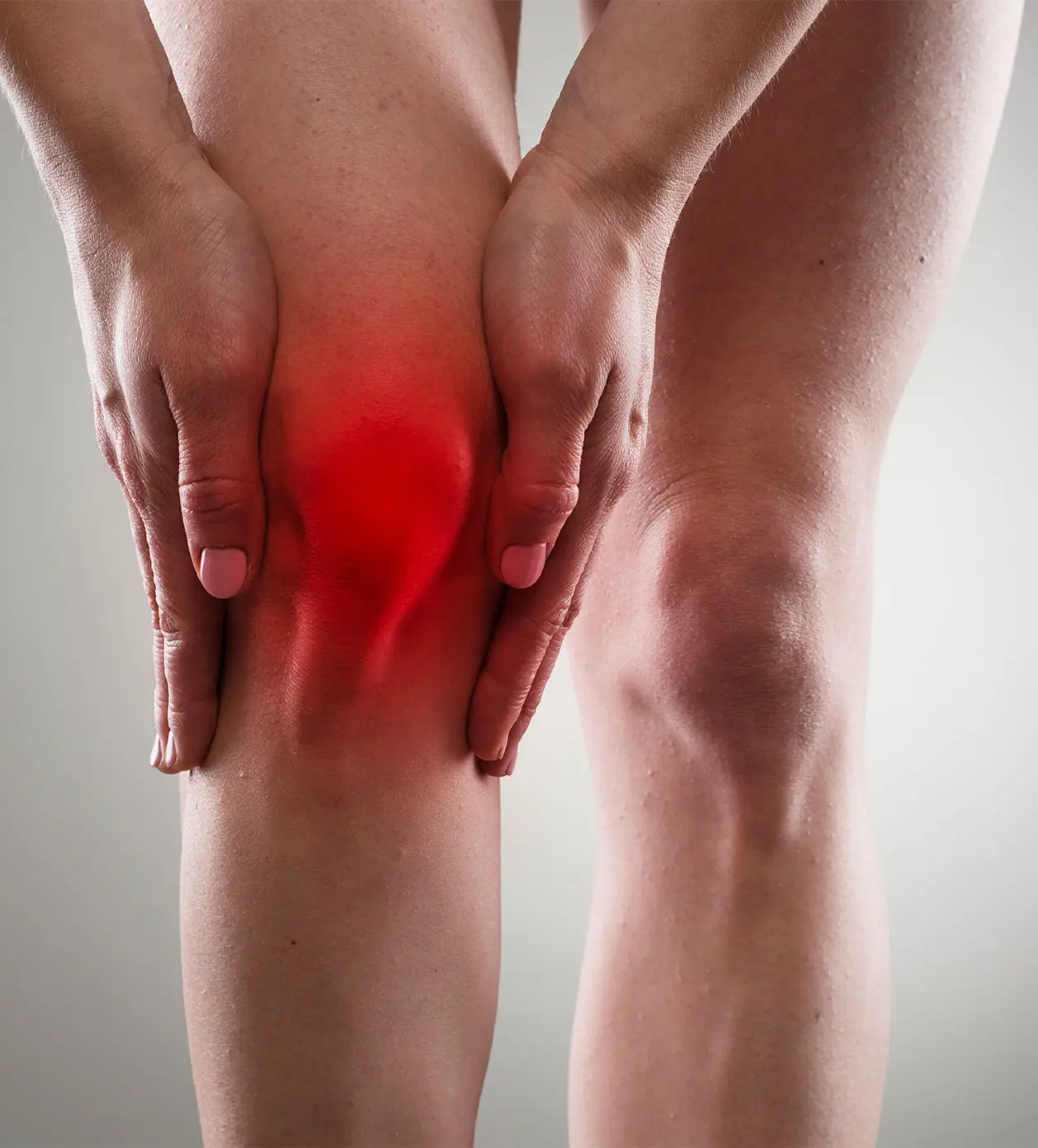 A woman holding her knee in pain, showing a knee fracture