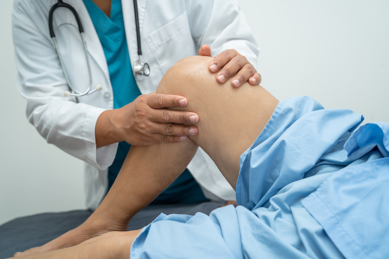 A patient being assessed for total knee replacement surgery